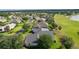 Back of a house with a lovely lawn in a residential neighborhood that borders a golf course and a lake at 1721 Sunset Ridge Dr, The Villages, FL 32162