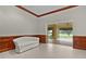 Sitting area features a white sofa, wood trim and a view of outdoor area at 1721 Sunset Ridge Dr, The Villages, FL 32162