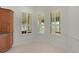 Sitting area featuring white walls, tile flooring and plantation shutters on the windows at 1721 Sunset Ridge Dr, The Villages, FL 32162