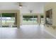 Bright sunroom with tile floors and large windows overlooking the golf course at 1721 Sunset Ridge Dr, The Villages, FL 32162