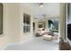 Neutral sunroom featuring tile flooring and a comfortable seating area at 1721 Sunset Ridge Dr, The Villages, FL 32162