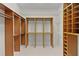 Spacious walk-in closet features built-in wood shelving and wire racks at 1721 Sunset Ridge Dr, The Villages, FL 32162