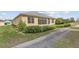 Charming home featuring a screened-in patio, lush landscaping and well-maintained lawn at 1724 Madero Dr, The Villages, FL 32159