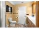 Bathroom with a toilet, vanity with drawers, and a towel rack at 17587 Se 95Th Cir, Summerfield, FL 34491