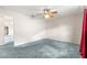 A primary bedroom includes carpet flooring and a ceiling fan at 17587 Se 95Th Cir, Summerfield, FL 34491