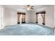 Bright bedroom featuring a ceiling fan and two windows with decorative curtains at 17587 Se 95Th Cir, Summerfield, FL 34491