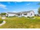Well-manicured lawn and landscaping surround this single-Gathering home with a brick driveway at 17587 Se 95Th Cir, Summerfield, FL 34491