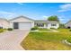 Charming single-story home with a well-manicured lawn and inviting curb appeal at 17587 Se 95Th Cir, Summerfield, FL 34491