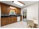 A well-lit kitchen features granite countertops, tiled floors, and wood cabinets at 17587 Se 95Th Cir, Summerfield, FL 34491