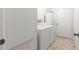 Functional laundry area equipped with a washer, dryer, and storage cabinet at 17587 Se 95Th Cir, Summerfield, FL 34491