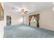 Spacious living room with a ceiling fan and a large window providing natural light at 17587 Se 95Th Cir, Summerfield, FL 34491