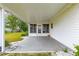 A covered patio area with concrete flooring, offering space for outdoor seating and entertainment at 17587 Se 95Th Cir, Summerfield, FL 34491