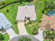 Aerial view of a home featuring lush landscaping, a screen patio, and a well-maintained yard at 1875 Saybrook Way, The Villages, FL 32162