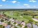 Residential area with golf course, lake, homes, and trees at 1875 Saybrook Way, The Villages, FL 32162