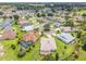 Aerial view of a residential neighborhood featuring mature trees and well-manicured lawns at 1875 Saybrook Way, The Villages, FL 32162
