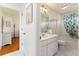 Bathroom with a tub/shower, white tile, and a vanity featuring a marble countertop at 1875 Saybrook Way, The Villages, FL 32162