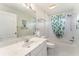 Bathroom featuring a vanity with marble countertops, white tile, and a combined tub and shower at 1875 Saybrook Way, The Villages, FL 32162