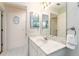 Bright bathroom with a marble countertop vanity and tile flooring at 1875 Saybrook Way, The Villages, FL 32162