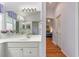 Bright bathroom featuring a white vanity with marble countertops and a large mirror at 1875 Saybrook Way, The Villages, FL 32162