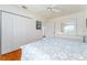 Bedroom featuring hardwood floors, a ceiling fan, a double door closet and a white dresser at 1875 Saybrook Way, The Villages, FL 32162