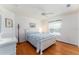 Bright bedroom with hardwood floors, a ceiling fan, and a large window with blinds at 1875 Saybrook Way, The Villages, FL 32162