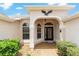Close up of the front entryway with a decorative eagle accent and glass paneled door at 1875 Saybrook Way, The Villages, FL 32162
