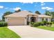 Charming single-story home with manicured landscaping and an attached two car garage at 1875 Saybrook Way, The Villages, FL 32162