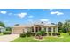 Charming single-story home featuring a well-manicured lawn, two car garage and attractive landscaping at 1875 Saybrook Way, The Villages, FL 32162