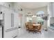 Eat-in kitchen area featuring a white refrigerator, table with chairs, and views from the window at 1875 Saybrook Way, The Villages, FL 32162