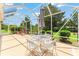 Outdoor patio with seating, perfect for outdoor meals and enjoyment of backyard scenery under shaded cover at 1875 Saybrook Way, The Villages, FL 32162
