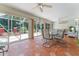 This sunroom is perfect for enjoying the outdoors, with its large windows and comfortable seating and access to patio at 1875 Saybrook Way, The Villages, FL 32162