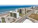 Aerial view of the Oceanside Inn building with nearby buildings at 1909 S Atlantic Ave # 311312, Daytona Beach, FL 32118