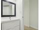 Bright bathroom featuring a modern vanity, large mirror, and neutral walls at 1909 S Atlantic Ave # 311312, Daytona Beach, FL 32118