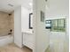 Well-lit bathroom featuring a white vanity and a tub with tile surround at 1909 S Atlantic Ave # 311312, Daytona Beach, FL 32118