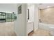 View into bright living room and an updated bathroom with sleek vanity and tiled shower-tub combination at 1909 S Atlantic Ave # 311312, Daytona Beach, FL 32118