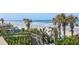 View of the beach from a landscaped vantage point with tropical palm trees at 1909 S Atlantic Ave # 311312, Daytona Beach, FL 32118