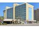 Exterior of Oceanside Inn highlighting the multiple levels of units and convenient porte-cochere entrance at 1909 S Atlantic Ave # 311312, Daytona Beach, FL 32118
