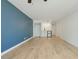 Bright living room featuring wood floors, ceiling fan, with a wet bar and closet at 1909 S Atlantic Ave # 311312, Daytona Beach, FL 32118