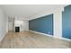 Bright living room with modern floors, a blue accent wall and kitchenette at 1909 S Atlantic Ave # 311312, Daytona Beach, FL 32118