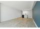 Bright living room with modern floors, a white wall and kitchenette at 1909 S Atlantic Ave # 311312, Daytona Beach, FL 32118