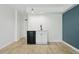 Bright living room with modern floors, a blue accent wall and kitchenette at 1909 S Atlantic Ave # 311312, Daytona Beach, FL 32118