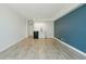 Bright living room with modern floors, a blue accent wall and kitchenette at 1909 S Atlantic Ave # 311312, Daytona Beach, FL 32118