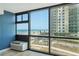 Ocean views from the living room window with a nearby building and blue skies at 1909 S Atlantic Ave # 311312, Daytona Beach, FL 32118