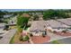 Aerial view of a cozy single-story home with a manicured lawn and vibrant landscaping with decorative rocks at 2128 Alfredo Ave, Lady Lake, FL 32159