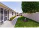 A backyard view features a long yard, lush lawn, mature landscaping, and access to a screened in patio at 2128 Alfredo Ave, Lady Lake, FL 32159