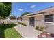 A cozy backyard space with a well-maintained lawn, trimmed shrubs, and a paved patio next to the home at 2128 Alfredo Ave, Lady Lake, FL 32159