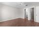 Spacious bedroom with hardwood floors and attached bathroom and closet entrances at 2128 Alfredo Ave, Lady Lake, FL 32159