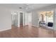 Bedroom with wood flooring, ceiling fan, and access to bathroom and screened patio at 2128 Alfredo Ave, Lady Lake, FL 32159