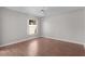 Bright bedroom featuring hardwood flooring, a ceiling fan, and a large window at 2128 Alfredo Ave, Lady Lake, FL 32159