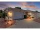 Charming single-story home featuring an attached garage, inviting walkway, and manicured landscaping at 2128 Alfredo Ave, Lady Lake, FL 32159